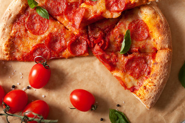 Pepperoni pizza with salami and cheese on a rustic table