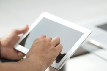 close up. digital tablet in the hands of a businessman