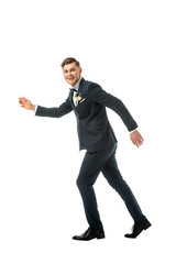 tricky cheerful bridegroom imitating running away isolated on white