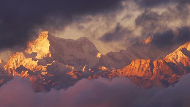 Time-lapse close-up cloud moving in front of Kangchenjunga mount at twilight time , Zoom out.