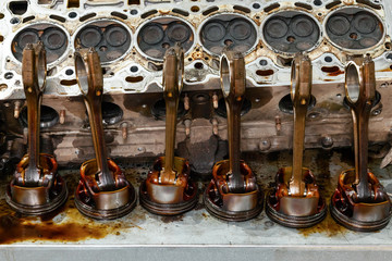 Part of the engine removed from a used car for repairing silver metal and aluminum with six pistons...