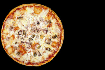 Fresh pizza with meat beaf chicken pork, tomatoes, vegetables, ushrooms on dark black background closeup