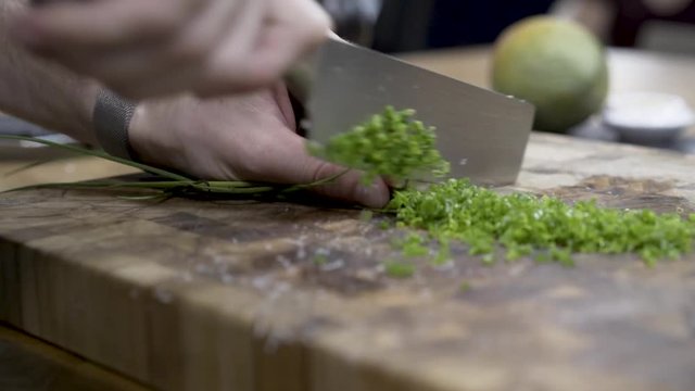 Close-up hands Cutting chive with gloves and kitchen knife