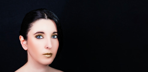 Young beautiful woman with bright makeup on a black background.