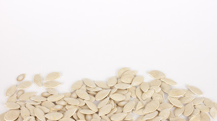 raw superfoods pumpkin seeds on white background