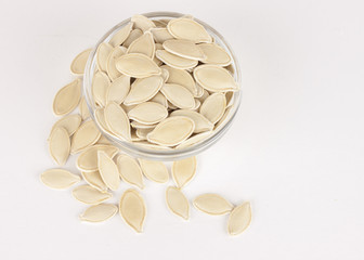 raw superfoods pumpkin seeds on white background