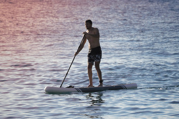 Fototapeta na wymiar man on the paddle board.