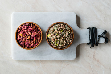 Raw and Roasted Wooden Bowl of Peeled Pistachios without Shell / with No Shell