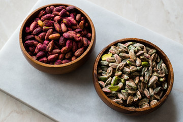 Raw and Roasted Wooden Bowl of Peeled Pistachios without Shell / with No Shell