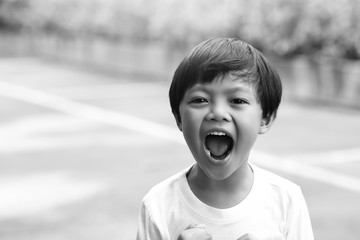 A portrait of angry boy shouting,black and white tone.