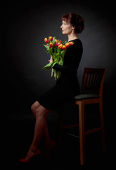 Attractive woman with a bouquet of tulips.
