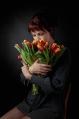 Attractive woman with a bouquet of tulips.