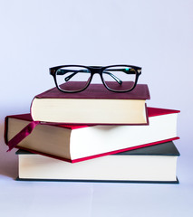 Image with books and glasses on white background