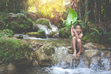 Fototapeta premium Children play happily in the stream.