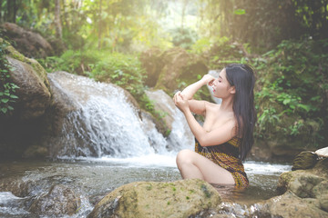 Fototapeta premium Happy bathing women at the natural waterfall.
