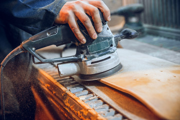 Carpenter using circular saw for cutting wooden boards. Construction details of male worker or...