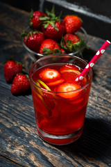 strawberry citrus lemonade on a dark background, top view, vertical