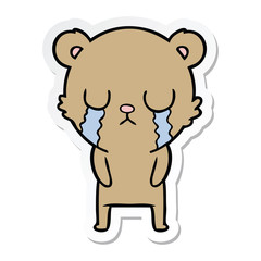 sticker of a cartoon bear crying