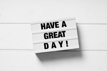 have a great day motivational text on light box light box sign on white wooden background
