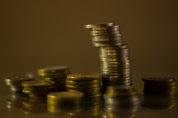 Different stacks of coins of lesser value, symbolize the regional economy and the different cost or payment indices.