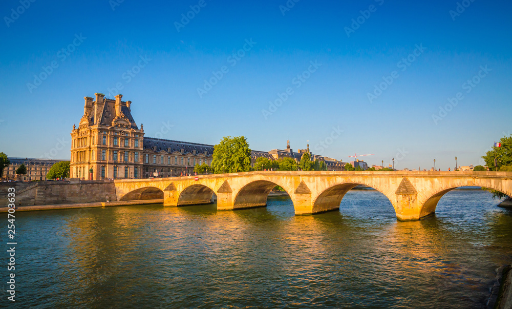 Wall mural Sunset view on bridge and buildings on the Seine river in Paris, France