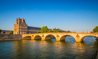 Fototapeta premium Sunset view on bridge and buildings on the Seine river in Paris, France