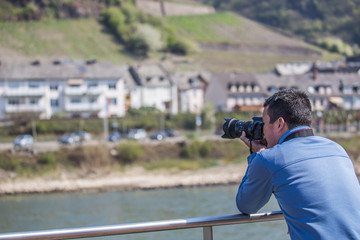 Man photographing castles on Rhine River