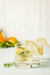 Festive summer drinks, pear thyme cocktail. Selective focus, space for text.