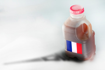 Canister with fuel and french flag on white background