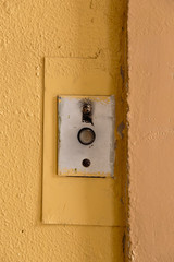 Old elevator call button with grungy pattern in a soviet building in post-soviet Riga, Latvia