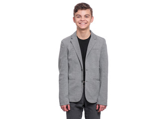 Handsome caucasian Teen Boy in gray suit isolated on white background. Teenager smiling and looking at camera. Happy child - half length portrait.