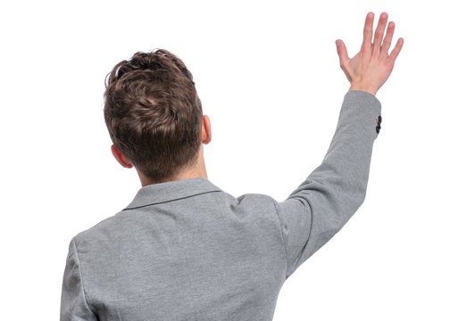 Back view of Handsome Teen Boy in gray suit stretching his right hand up for greeting. Portrait of caucasian Teenager waving hand isolated on white background. Stock Photo | Adobe Stock