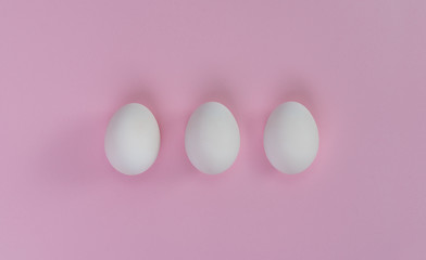 Three eggs in row. Creative concept. Relations.