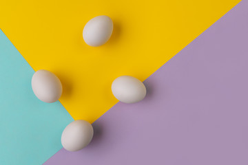 Eggs on multicolored background. Geometric easter concept.