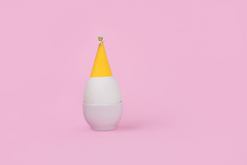 Egg warring magician yellow hat. Easter concept.