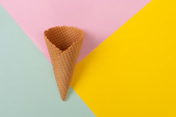 Ice cream cone on pastel colorful background. Minimal summer concept. Flat lay.