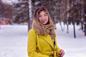 Young Asian girl walks through the park in winter