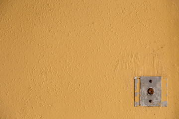 Old elevator call button with grungy pattern in a soviet building in post-soviet Riga, Latvia