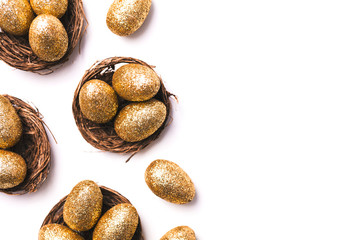 Golden glitter eggs in a nest. Easter background. Finance concept