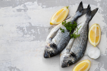 raw fish with olive oil and lemon background