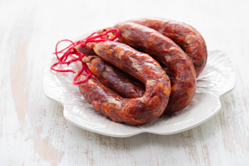 typical portuguese smoked sausages on beautiful white dish