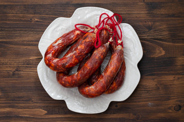 Portuguese smoked sausages Chourico on white dish