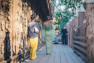 Female tourist take a photo at Shwe Nan Daw Kyaung (Golden Palace Monastery) in Mandalay, Myanmar.