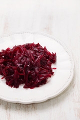 boiled beet on white plate on ceramic background