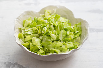 cabbage on the beautiful white bowl on ceramic background