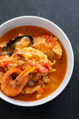 typical portuguese fish and seafood stew caldeirada in dish on ceramic background