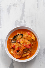 typical portuguese fish and seafood stew caldeirada in dish on ceramic background
