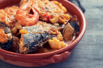 portuguese fish and seafood stew in dish on ceramic background