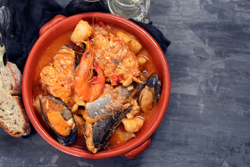 portuguese fish and seafood stew in dish on ceramic background