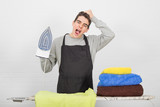 stressed man ironing clothes